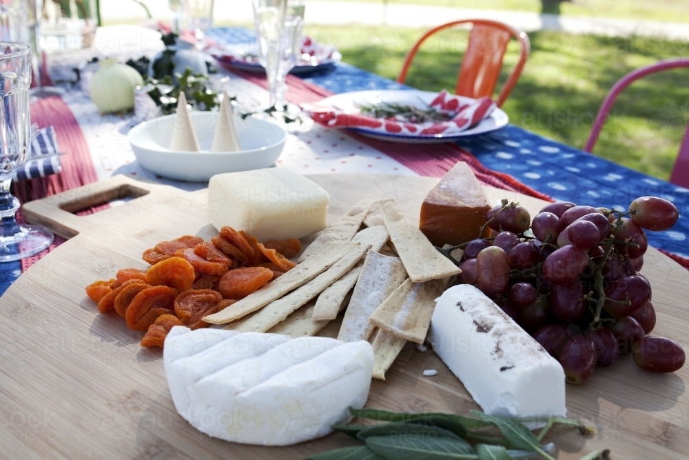 Cheese board on outdoor table ready for Christmas celebration - Australian Stock Image