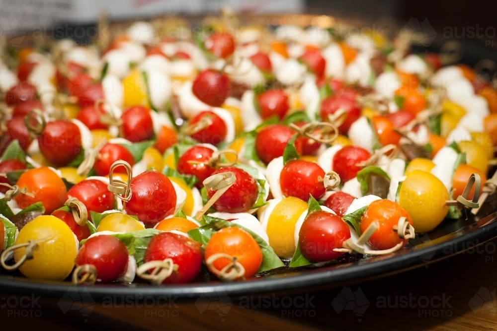 Cherry tomato and feta skewers on a tray - Australian Stock Image