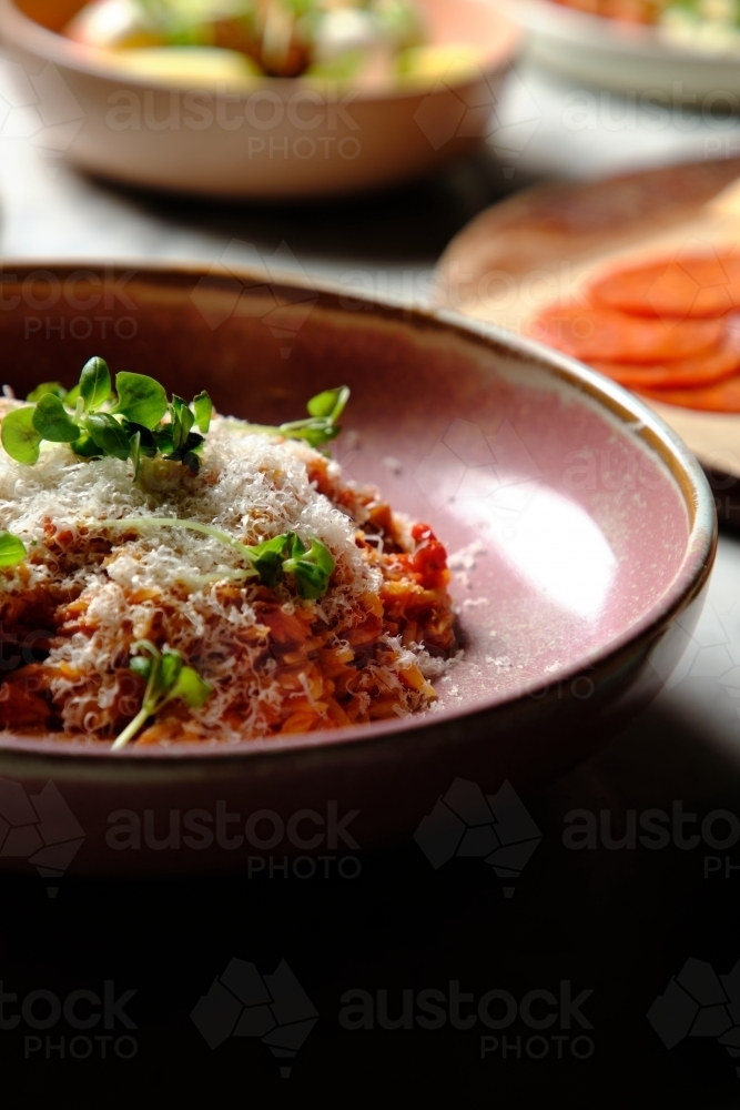 Cherry tomato sugo risoni in a pink bowl - Australian Stock Image