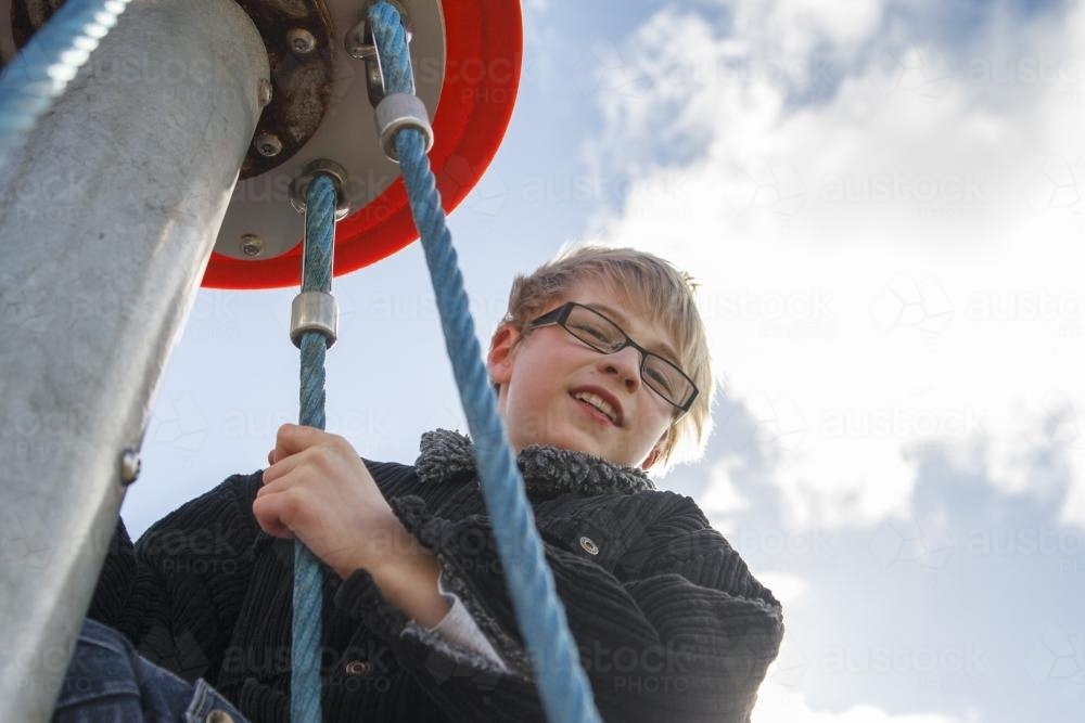 Child at top of playground equipment - Australian Stock Image