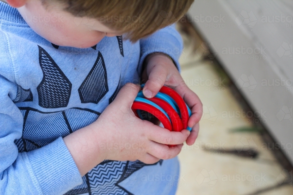 Child holding bunch of hookey rings - Australian Stock Image