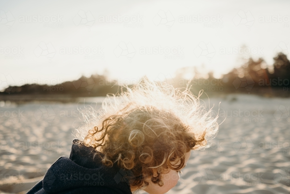 child on beach at sunset - Australian Stock Image
