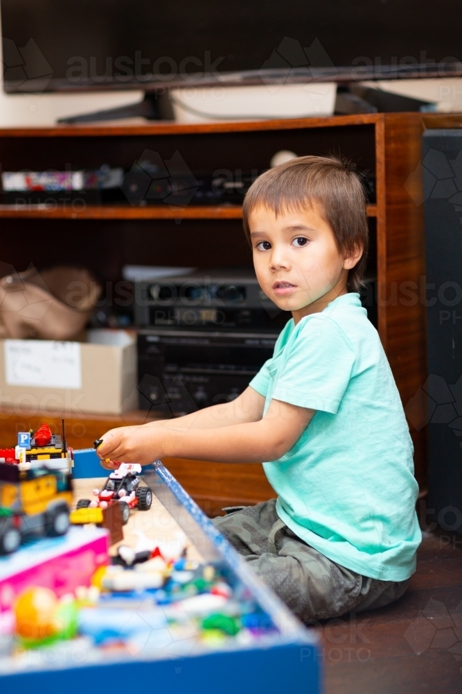 Child playing with toys at home - Australian Stock Image