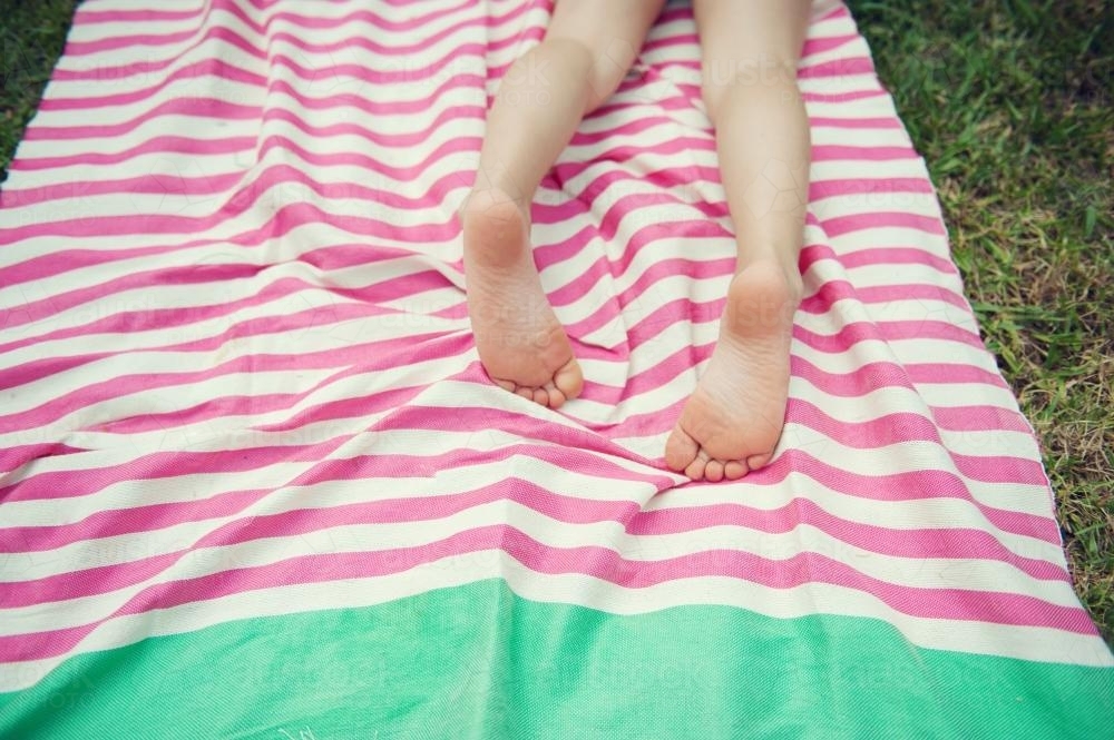 Child Sunbaking on a Turkish Towel - Australian Stock Image