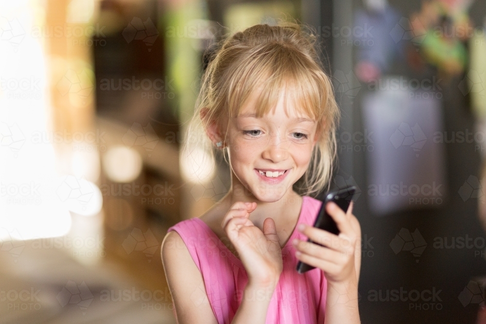 Child with mobile phone - Australian Stock Image
