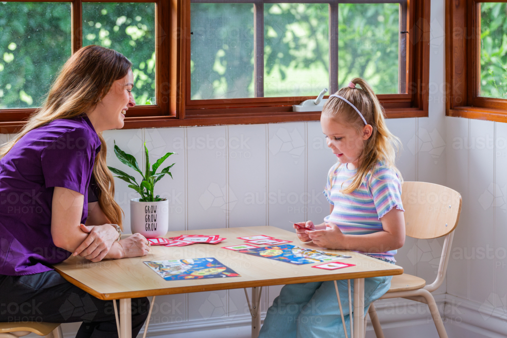 Image of Child with speech disability looking at sound cards talking ...