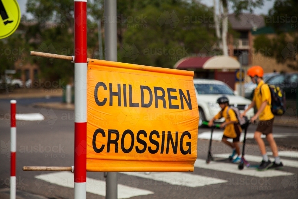 Children crossing sign at zebra crossing beside Aussie Public school - Australian Stock Image