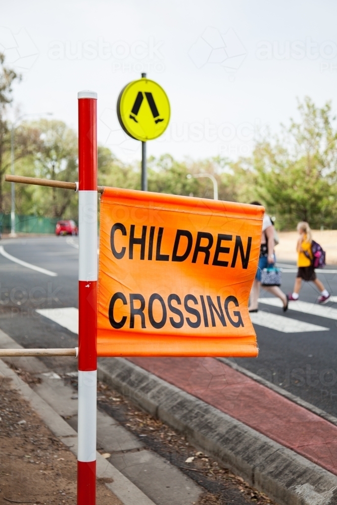 Children crossing sign at zebra crossing beside Aussie Public school - Australian Stock Image