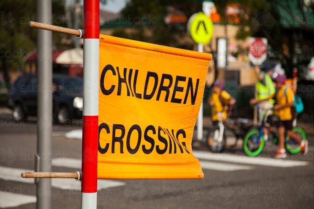 Children crossing sign at zebra crossing beside Aussie Public school - Australian Stock Image