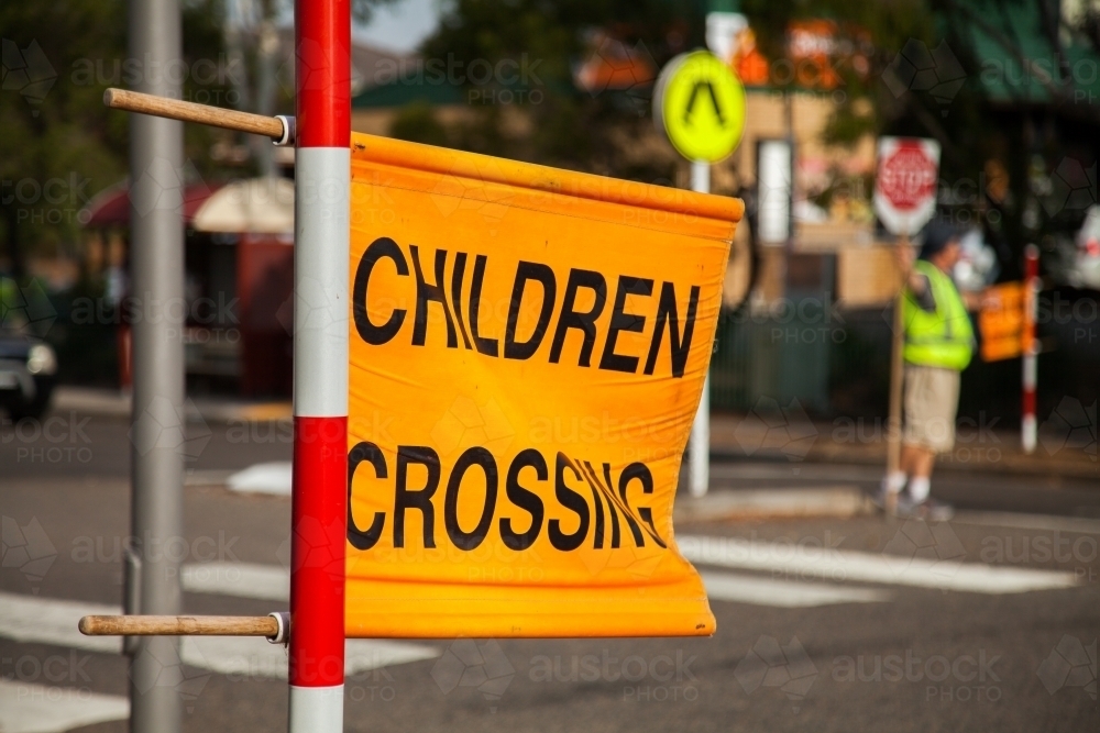 Children crossing sign at zebra crossing beside Aussie Public school - Australian Stock Image
