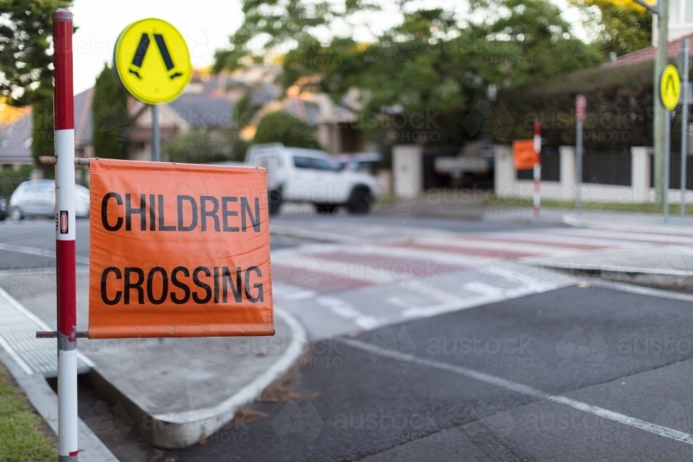 Children crossing sign on roadside at pedestrian crossing - Australian Stock Image