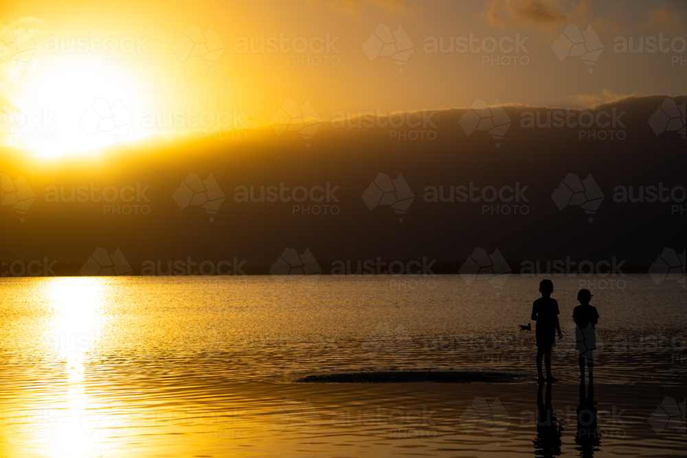 Children playing at sunset - Australian Stock Image