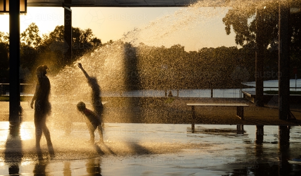 Children playing in a playground water jets at Eastshores recreation area, in Gladstone, Queensland - Australian Stock Image