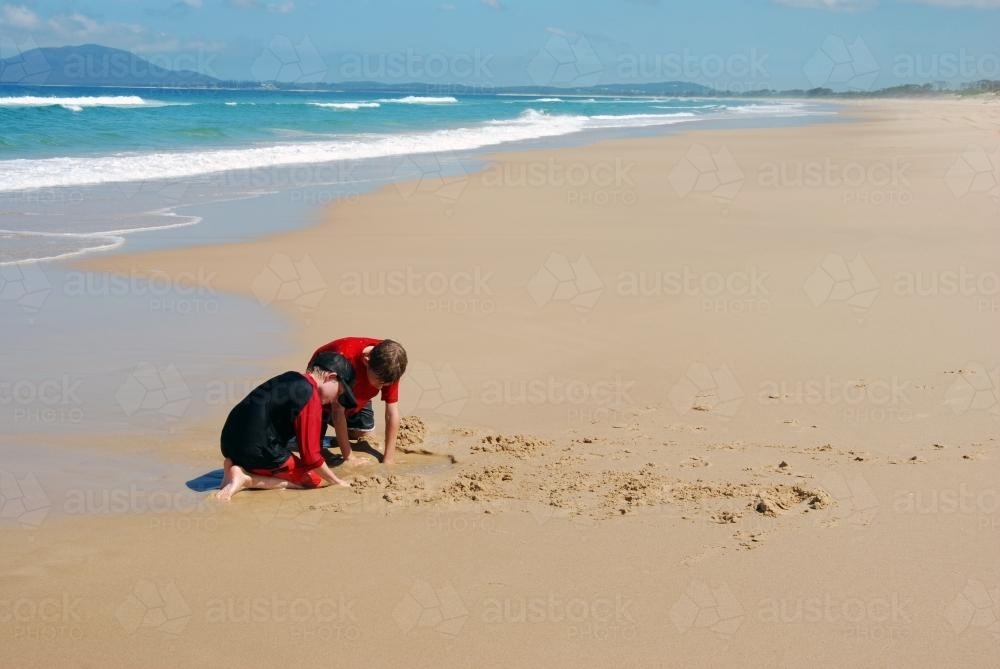 Children playing in the sand at the Beach - Australian Stock Image