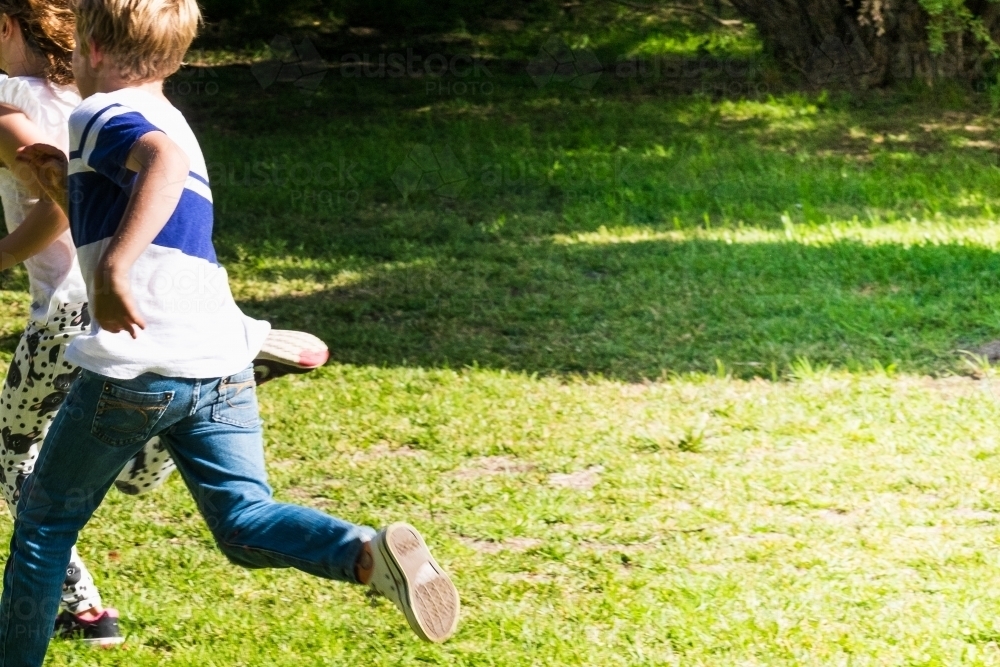 Children running in the parkland - Australian Stock Image