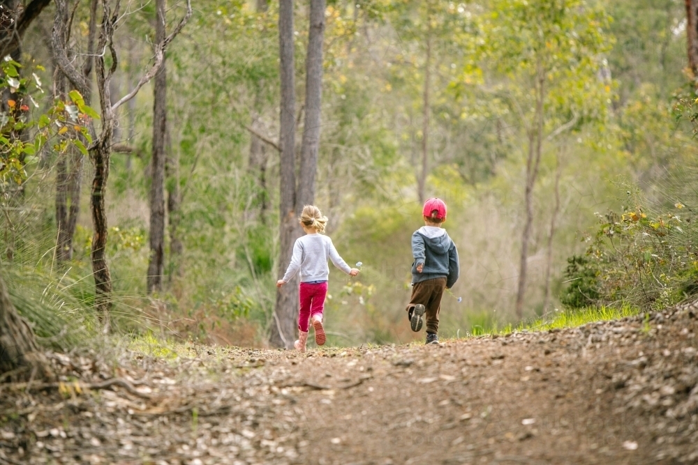 children running on bush track - Australian Stock Image