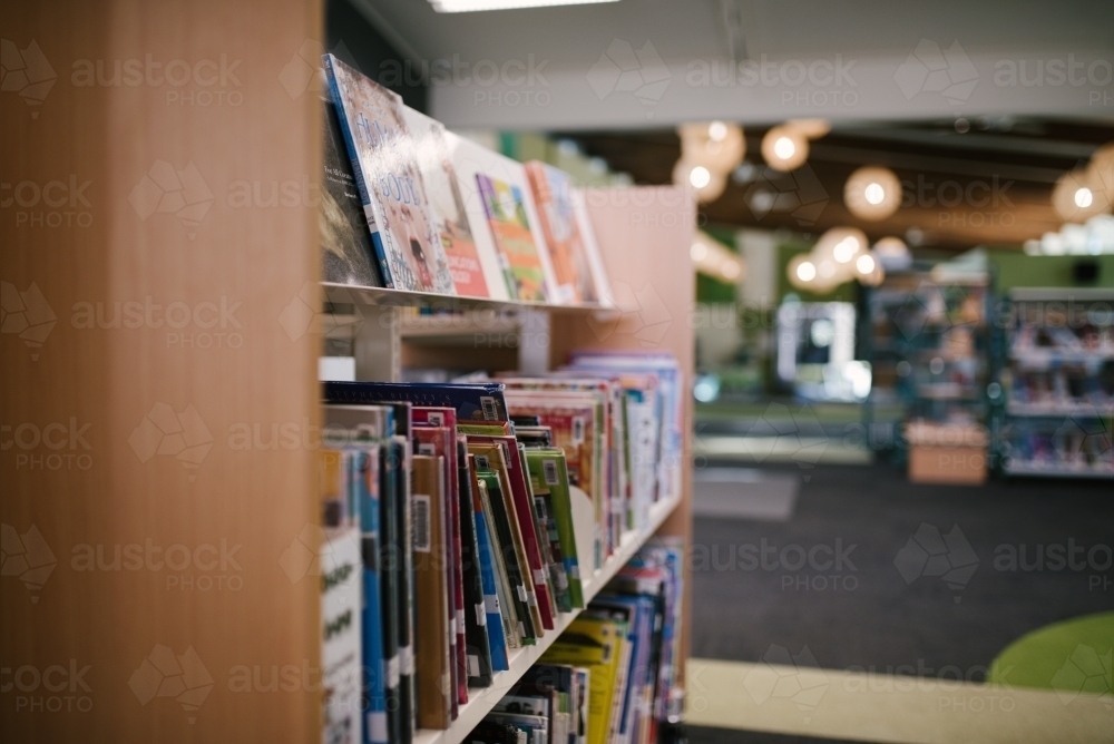 Children's books on a library shelf - Australian Stock Image
