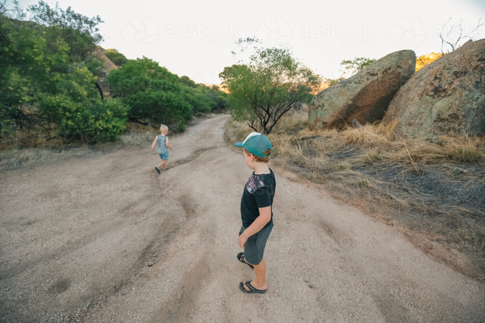 Children walking along bush track on Summer adventure - Australian Stock Image
