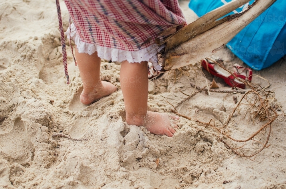 Childs feet on a sandy beach - Australian Stock Image