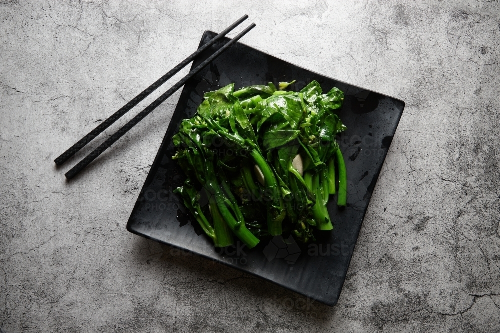 Chinese broccoli in ginger sauce dish - Australian Stock Image