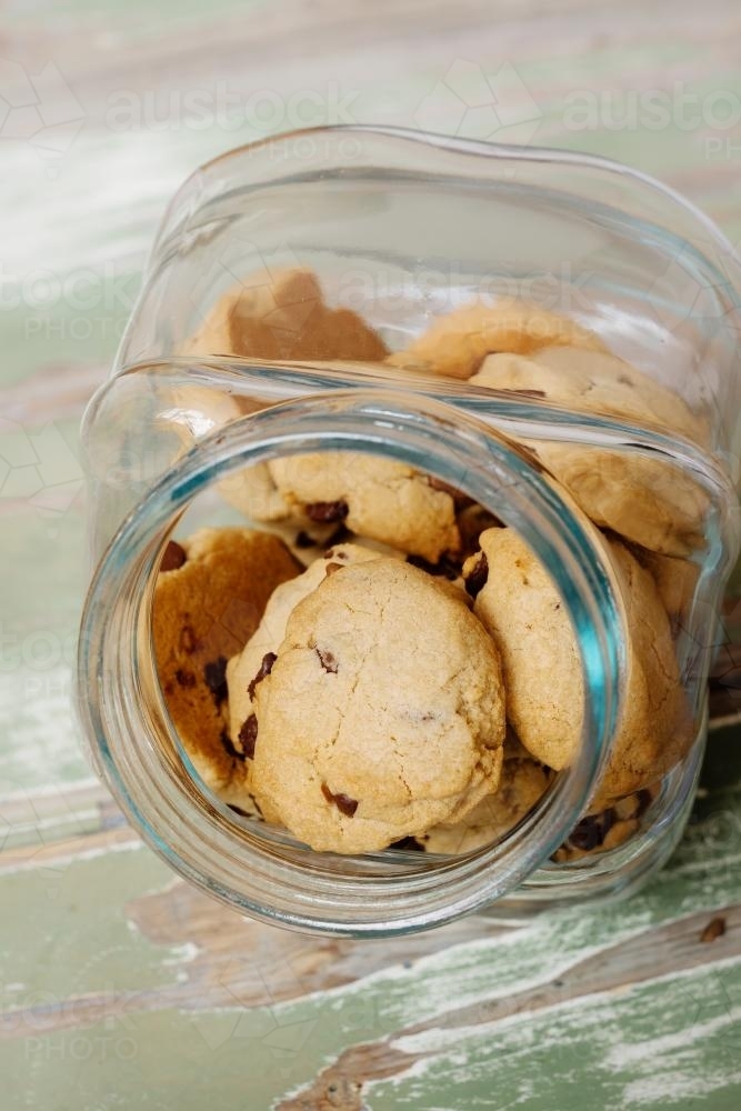 choc chip cookies in a glass cookie jar - Australian Stock Image