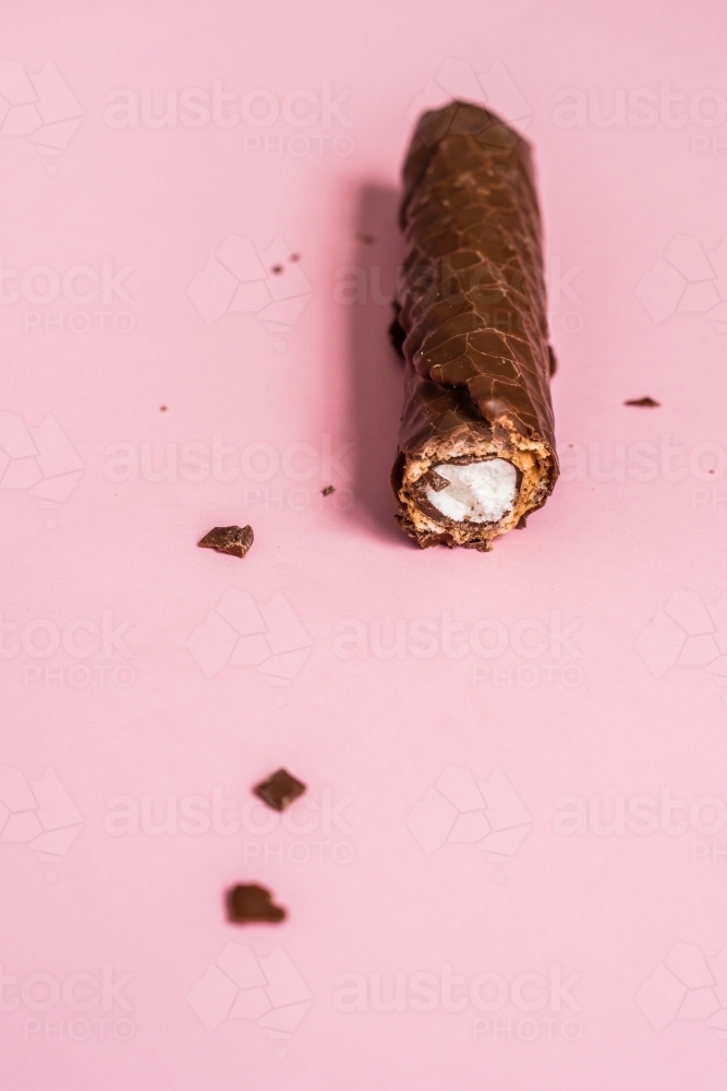 chocolate bar on pink background - Australian Stock Image