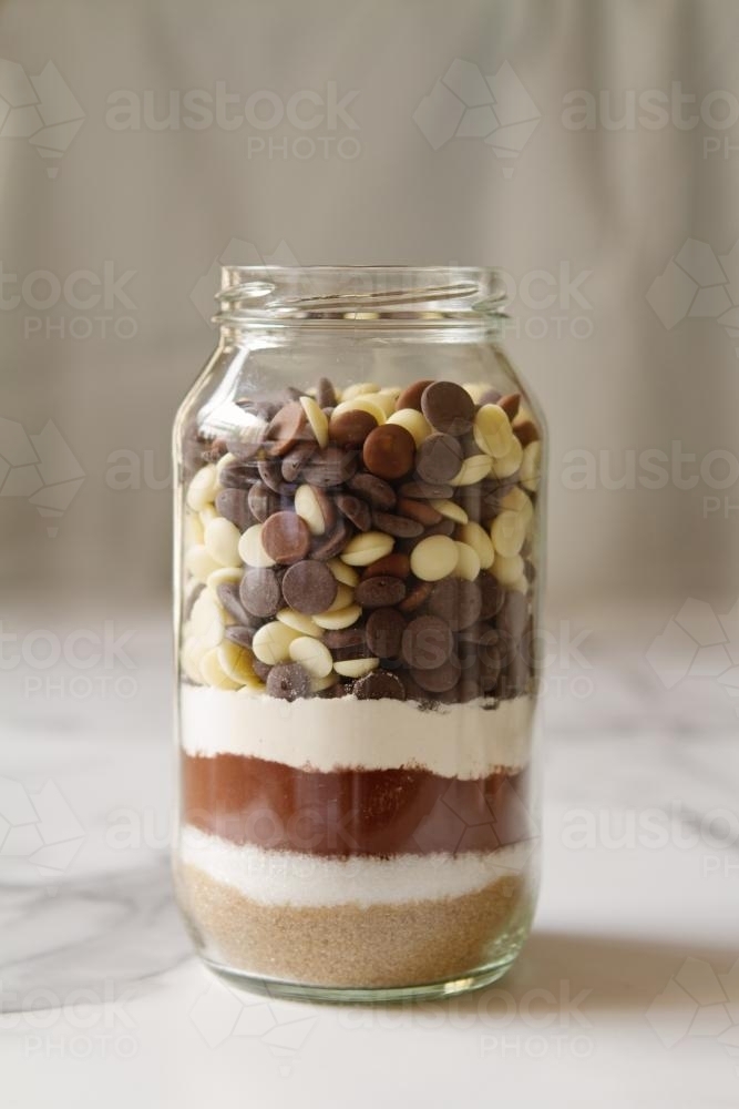 Chocolate brownie ingredients in a glass jar ready to make - Australian Stock Image