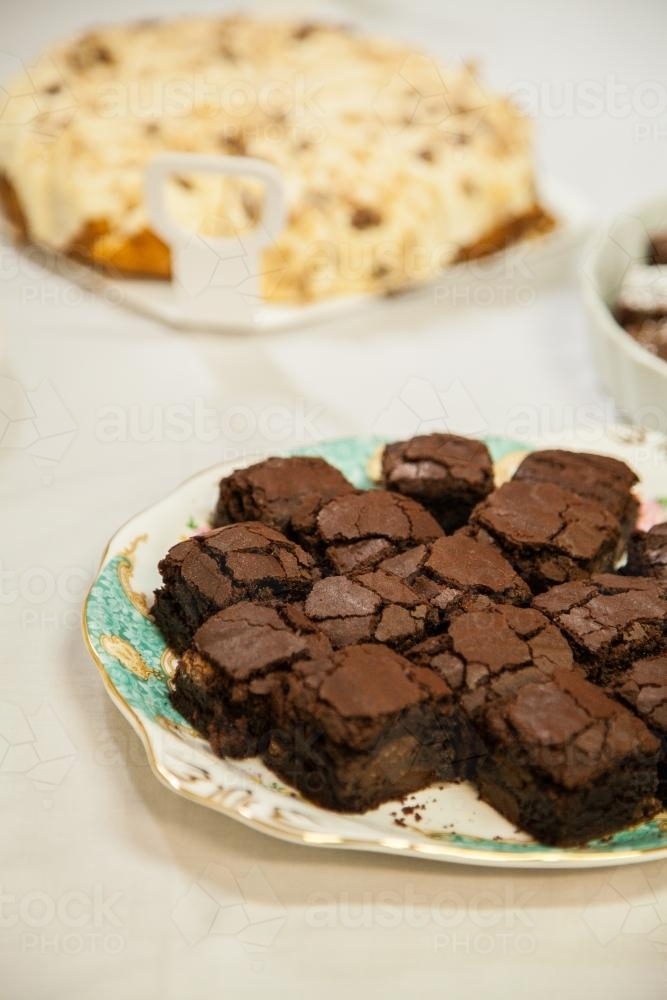 Chocolate brownie slice on a plate set out for a party - Australian Stock Image