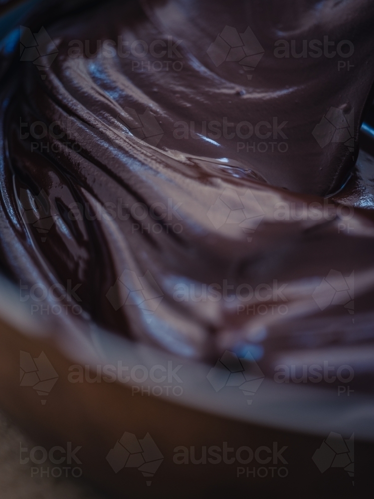 Chocolate icing mixture in bowl - Australian Stock Image
