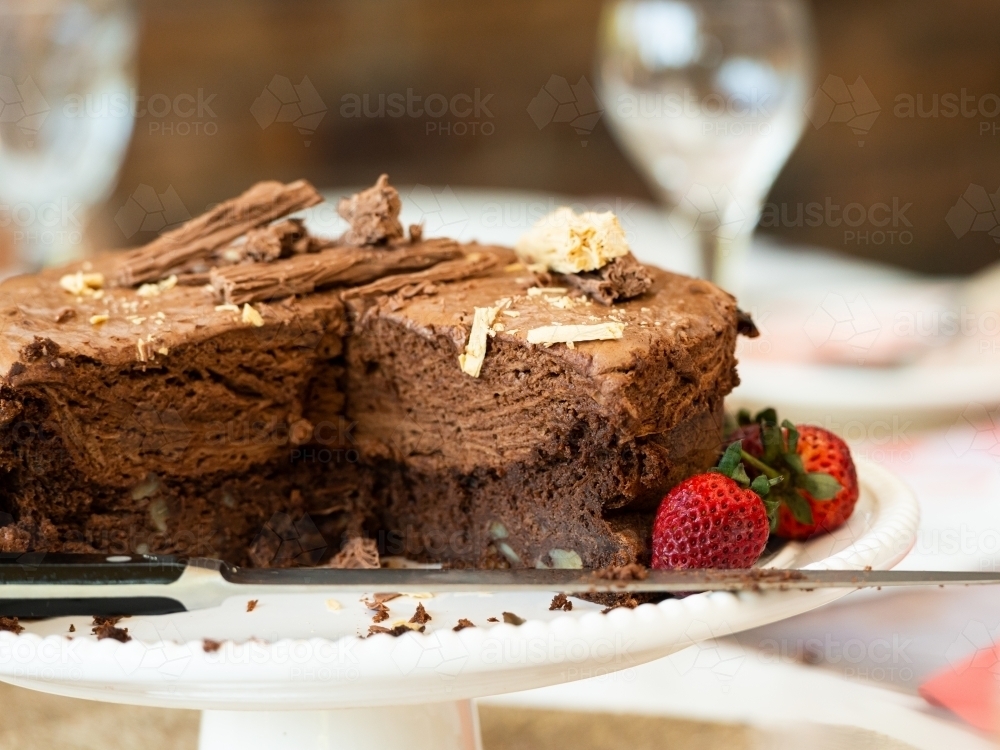 Chocolate mousse cake with strawberries and knife - Australian Stock Image