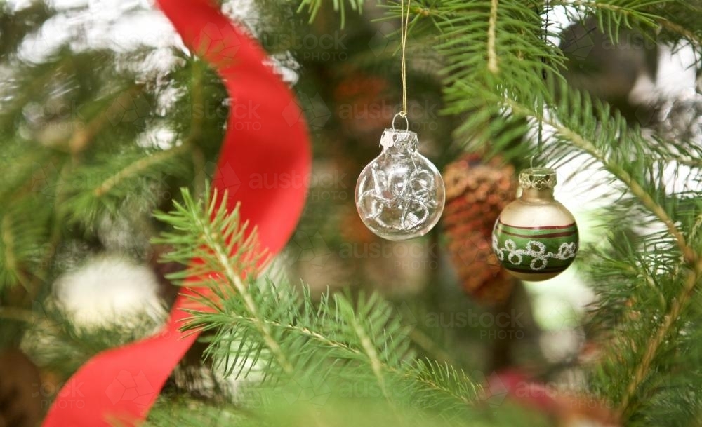 Christmas baubles and decorations hanging from trees - Australian Stock Image