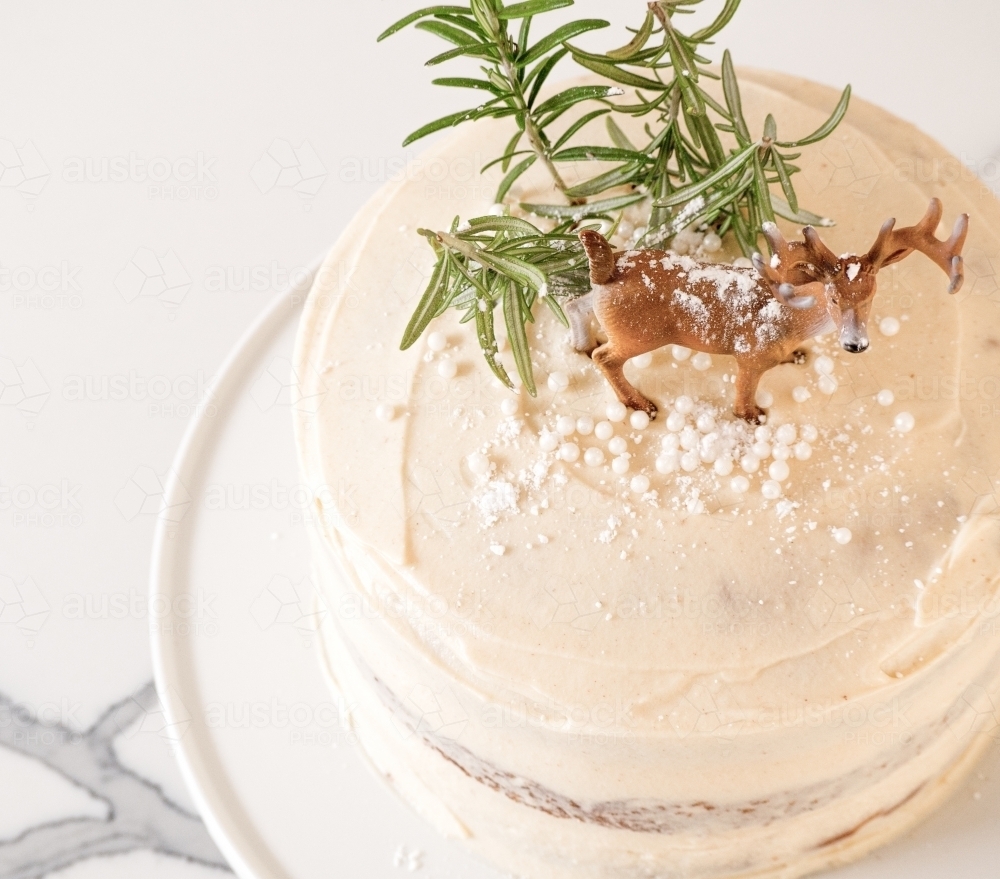 Christmas cake decorated with mini trees and a deer - Australian Stock Image