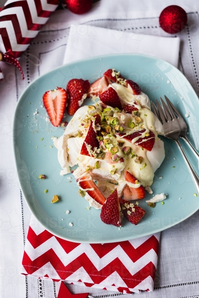 Christmas dessert, messy pavlova with with cream, strawberries and pistachio - Australian Stock Image