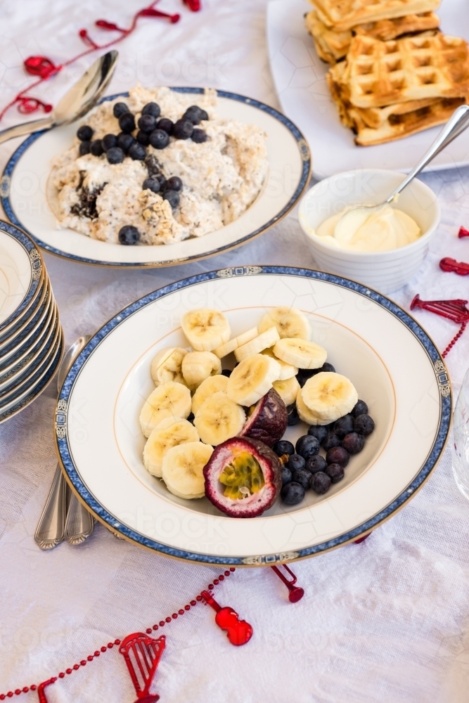 christmas morning breakfast, fruits, bircher and waffles - Australian Stock Image