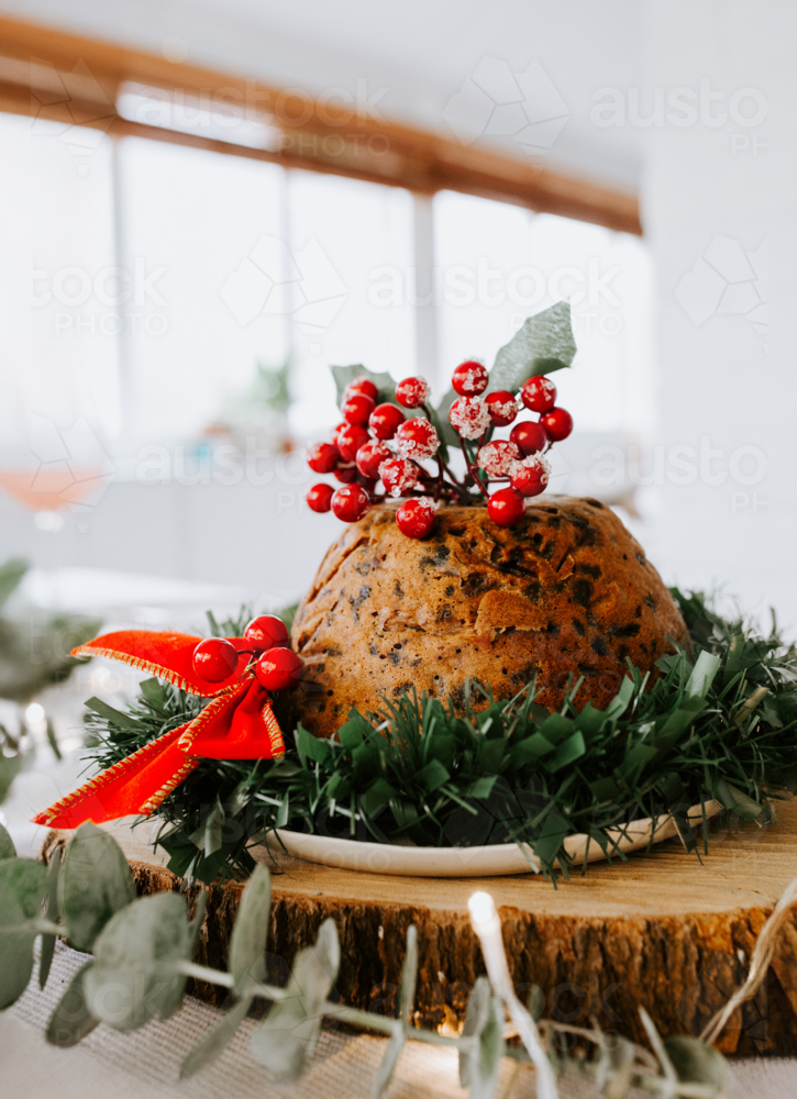 Christmas pudding fruit cake with ornament on a wooden board. - Australian Stock Image