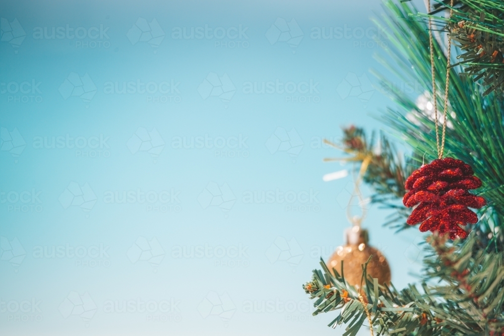 Christmas tree and baubles on the beach background. Out of focus background of aqua blue beach - Australian Stock Image