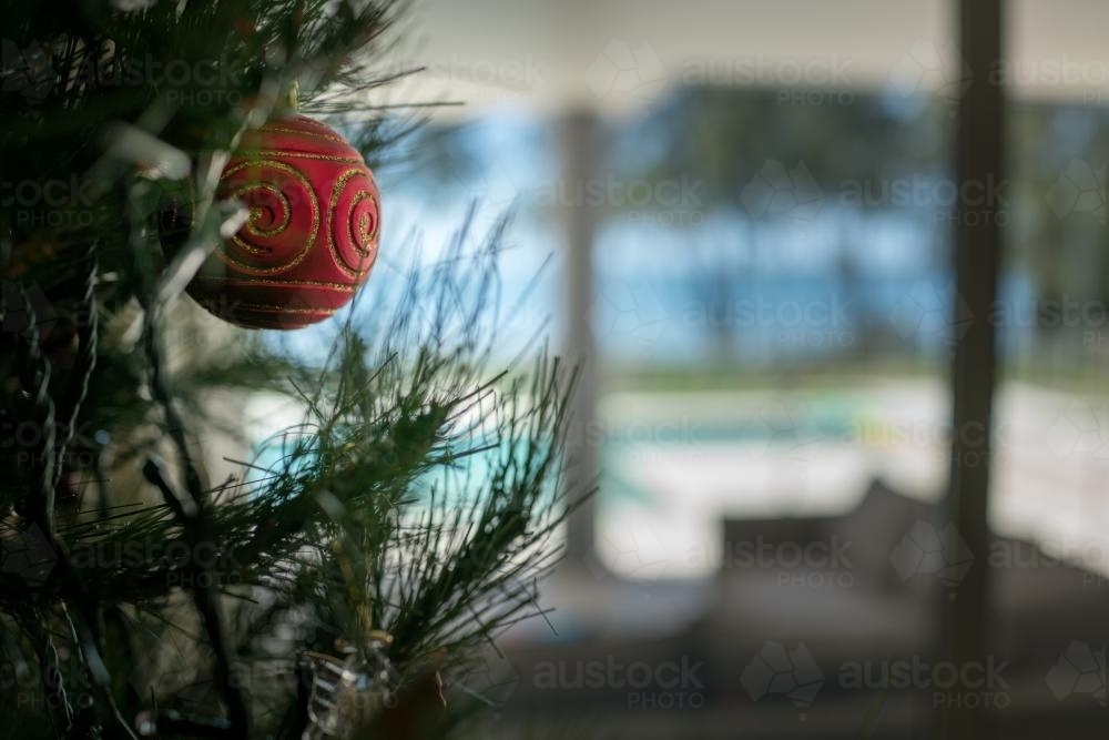 Christmas tree decoration in the summer with pool and lake in background - Australian Stock Image