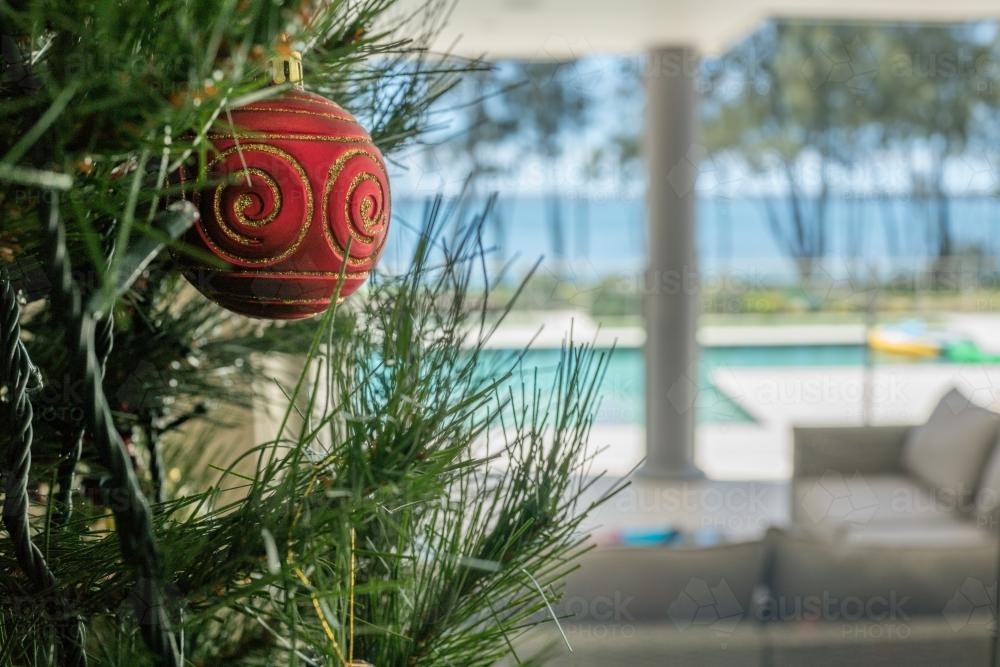 Christmas tree decoration in the summer with pool and lake in background - Australian Stock Image