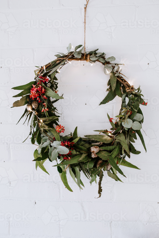 Christmas wreath of native Australian gum leaves hanging on the wall. - Australian Stock Image