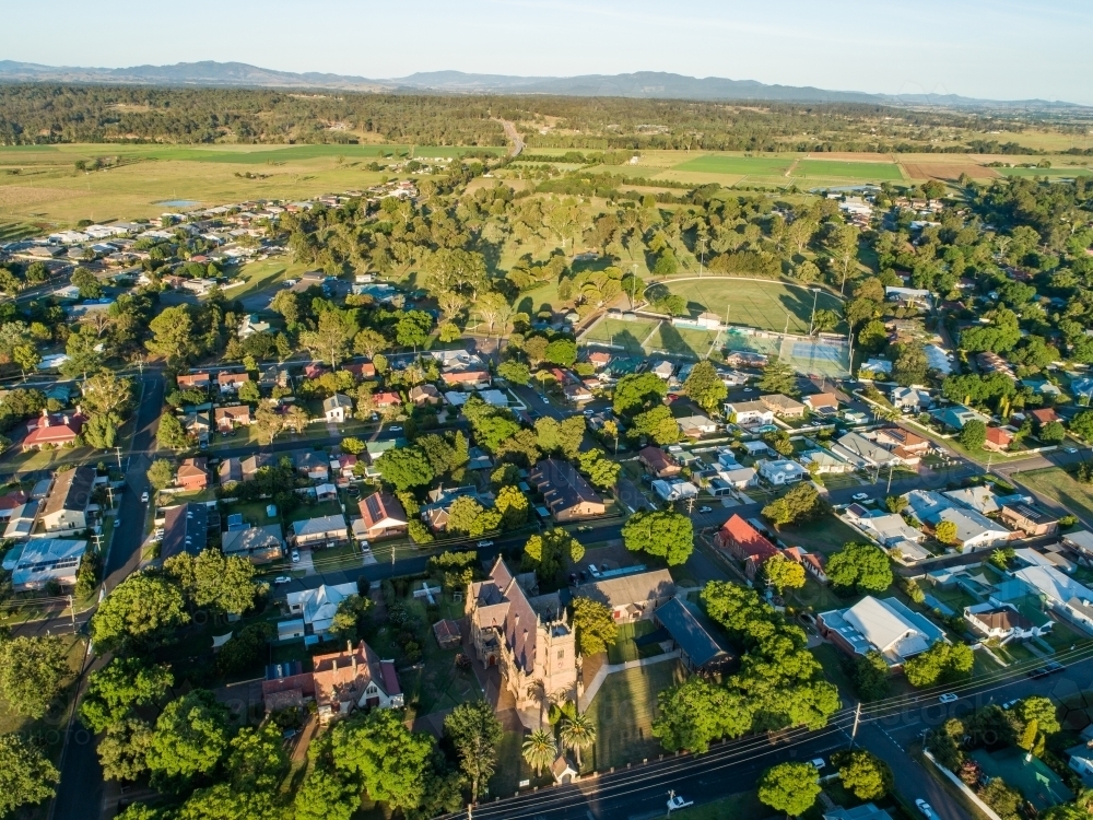 Church and houses along streets of country town in afternoon light with distant farmland : Austockphoto Church and houses along streets of country town in afternoon light with distant farmland - Australian Stock Image
