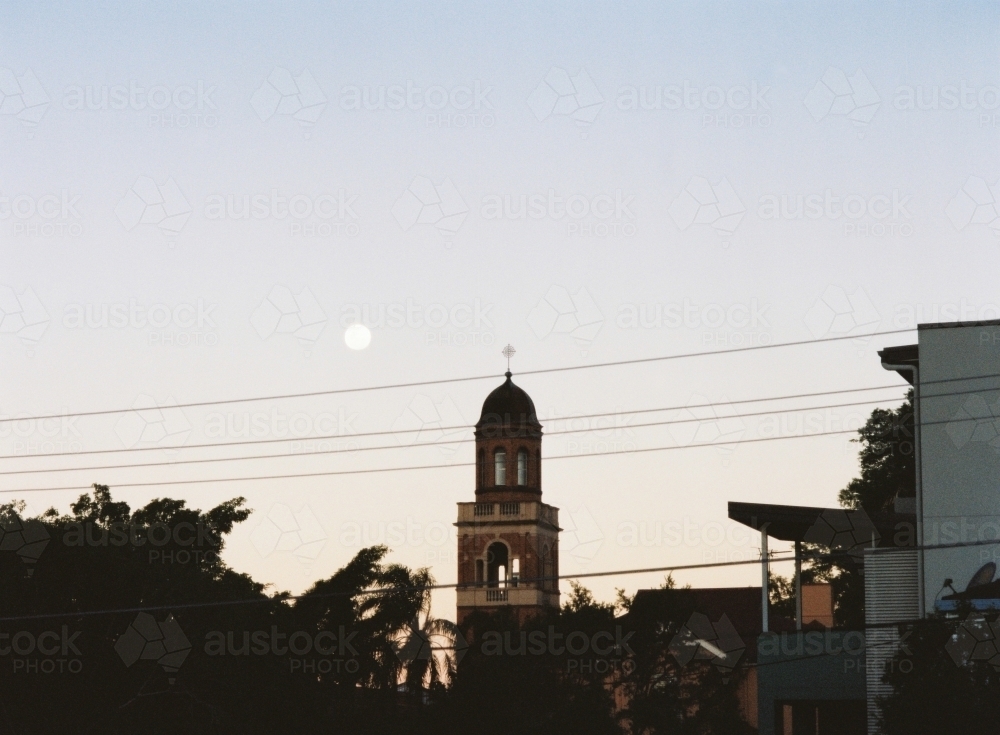 Church Steeple and city Silhouette under a Full Moon At Dusk - Australian Stock Image