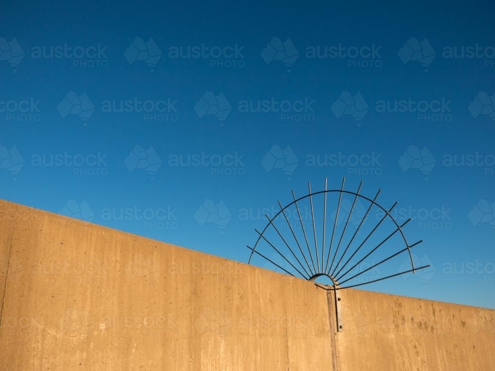 Circular spiked barrier to stop access to dam wall - Australian Stock Image