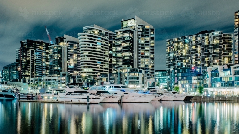 City lights and buildings reflected at night time at Victoria Harbour, Docklands - Australian Stock Image