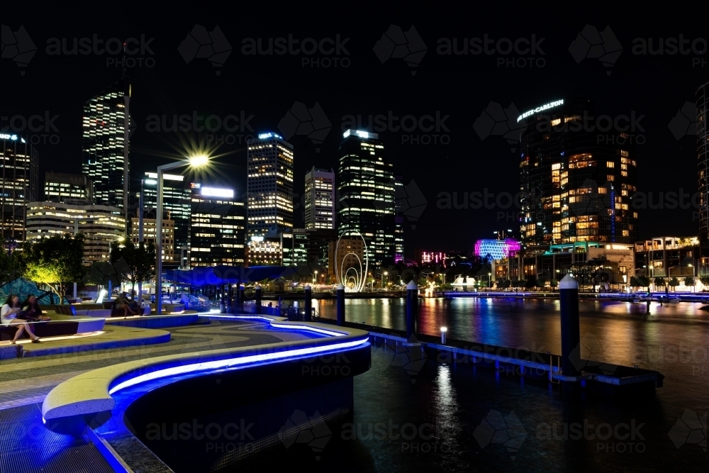 City lights with sky line, reflections in water and leading lines - Australian Stock Image