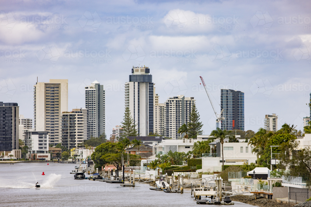 City skyline view of the Gold Coast across the Nerang River on an overcast day - Australian Stock Image