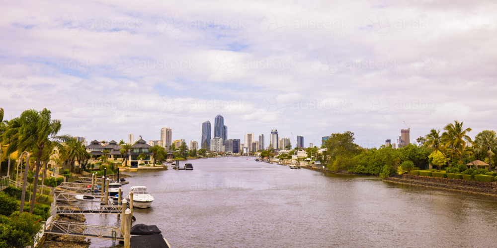 City skyline view of the Gold Coast across the Nerang River on overcast day - Australian Stock Image