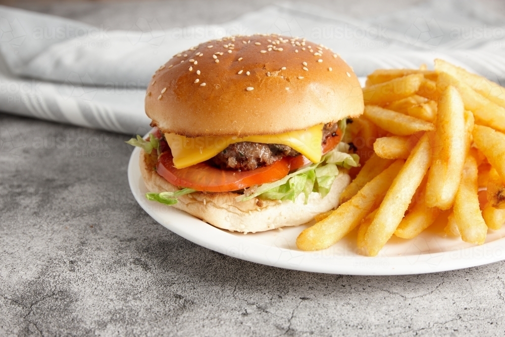 Image of classic beef burger with fenchfries on the side Austockphoto
