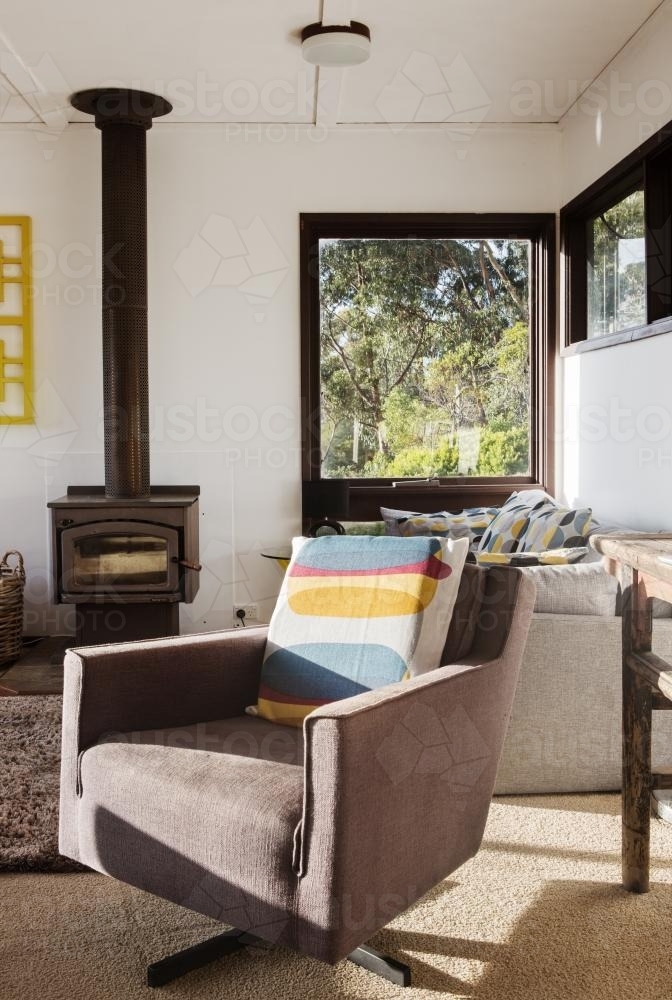 Classic vintage retro lounge recliner armchair in 70s beach house - Australian Stock Image
