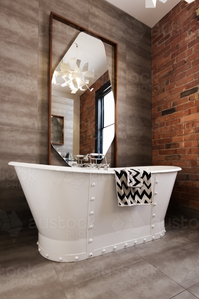 Classic white freestanding iron look bathtub in vintage style renovated bathroom - Australian Stock Image