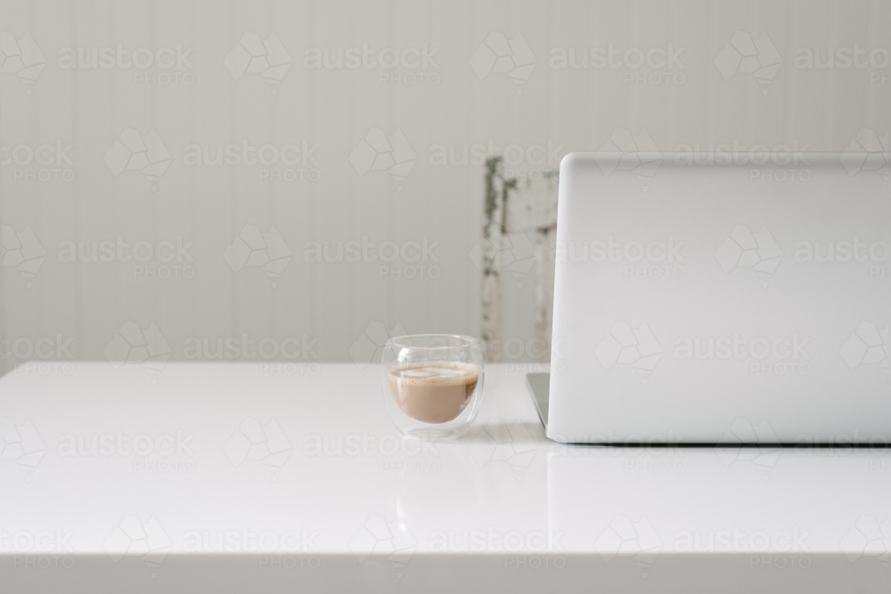 clean white desk with laptop and coffee and copy space - Australian Stock Image